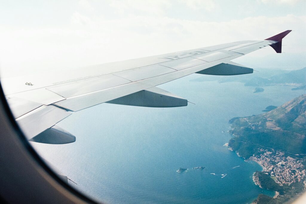 Looking out of an airplane window onto your destination, a tropical paradise.